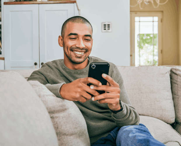Ultra - Man on Phone on Couch-600x520_compressed