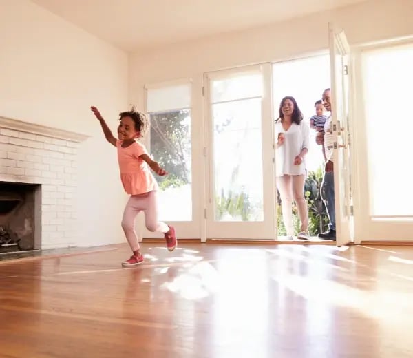 Family walking through the front door of their new home
