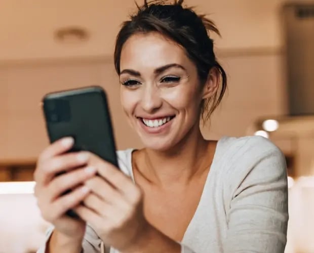 Woman setting up debit card controls on her smartphone