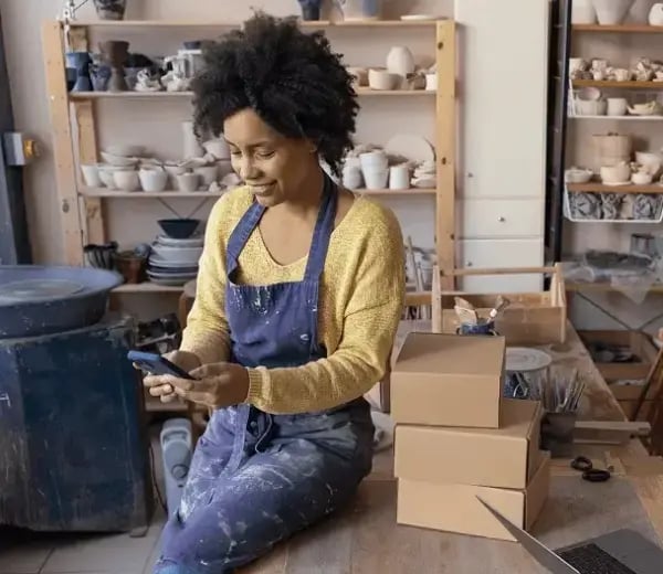 Business owner applying for an SBA loan on her cell phone