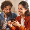Couple reviewing their HELOC offers on a smartphone