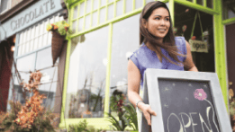 Entrepreneur opening shop after signing up for new business banking accounts