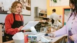 Employee using merchant services to complete a customer transaction