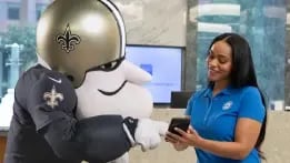 Sir Saint working with a Hancock Whitney associate to open a new checking account