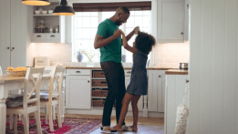 Father and daughter celebrate the new house the family bought with a mortgage