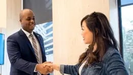 Banker welcoming a client to his office