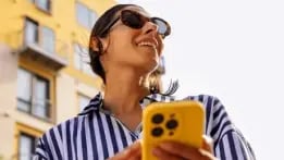 Woman enjoying her day while using the Hancock Whitney mobile app on her phone