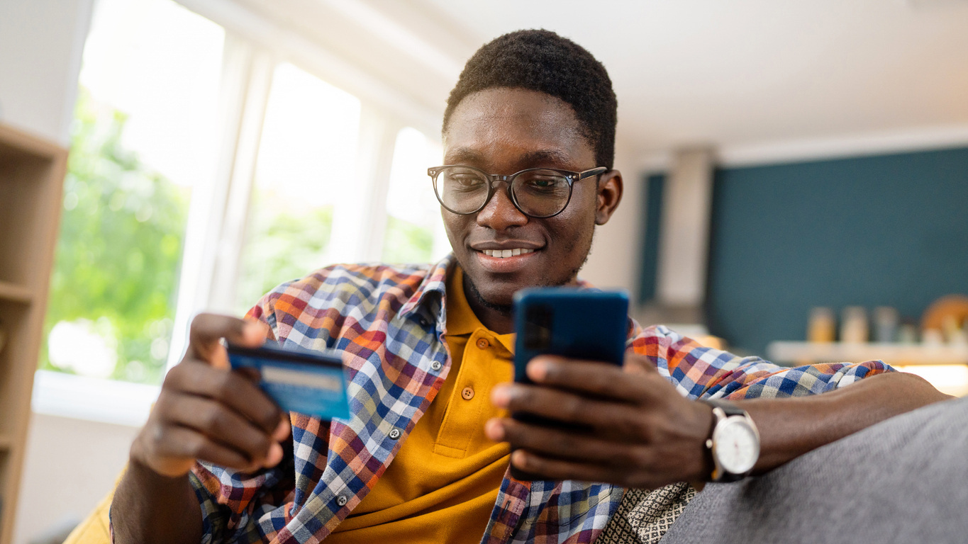 man using debit card on mobile