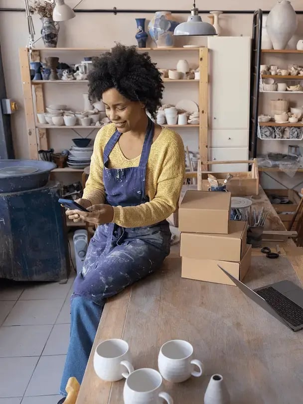 Woman checking her credit card balance on her cell phone