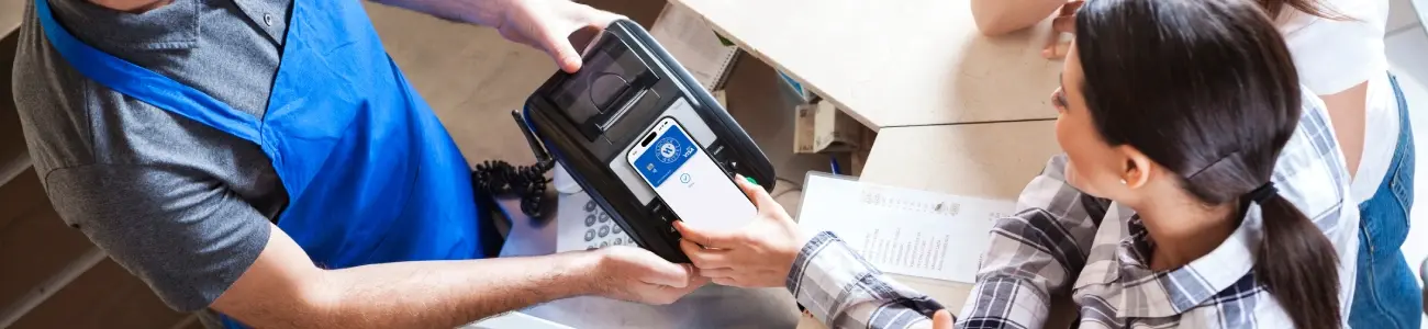 Customer using a mobile wallet on their cellphone to pay for a transaction