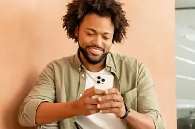 Man checking his account balance on his cell phone after his direct deposit completes