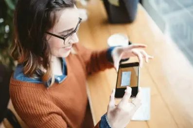 Woman using mobile deposit with a check