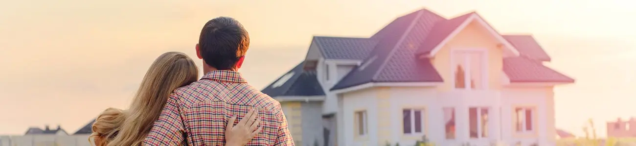 Couple admiring the home they just bought with a mortgage loan