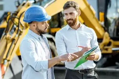 Executive discussing equipment needs with his foreman