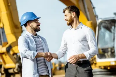 Company team members discussing equipment needs and financing options on a worksite