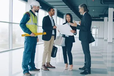 CRE team discussing plans for an office building