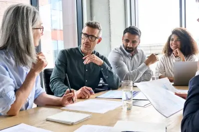 Business team discussing capital markets strategy