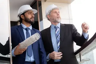 Corporate executive viewing commercial worksite with real estate agent