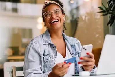 Woman using her cell phone to activate her new balance transfer credit card