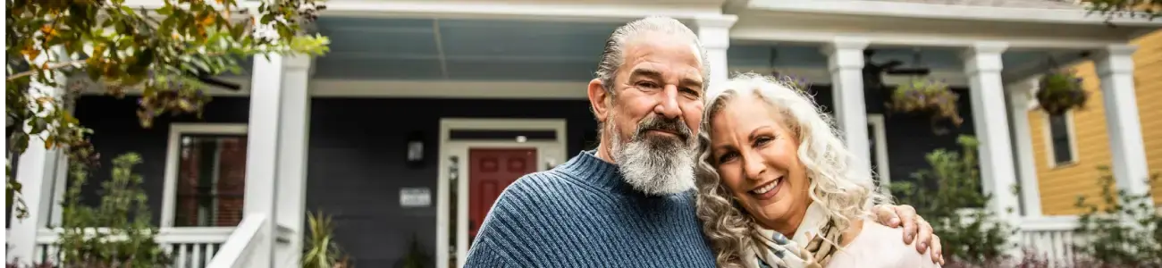 Man and woman in front of home - 1300x300